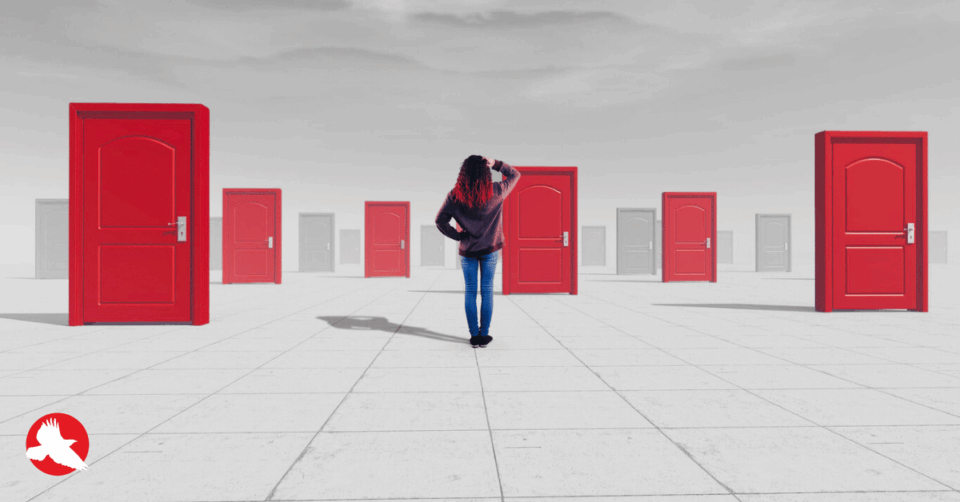 Executive standing at a decision point facing multiple paths after a product prototype
