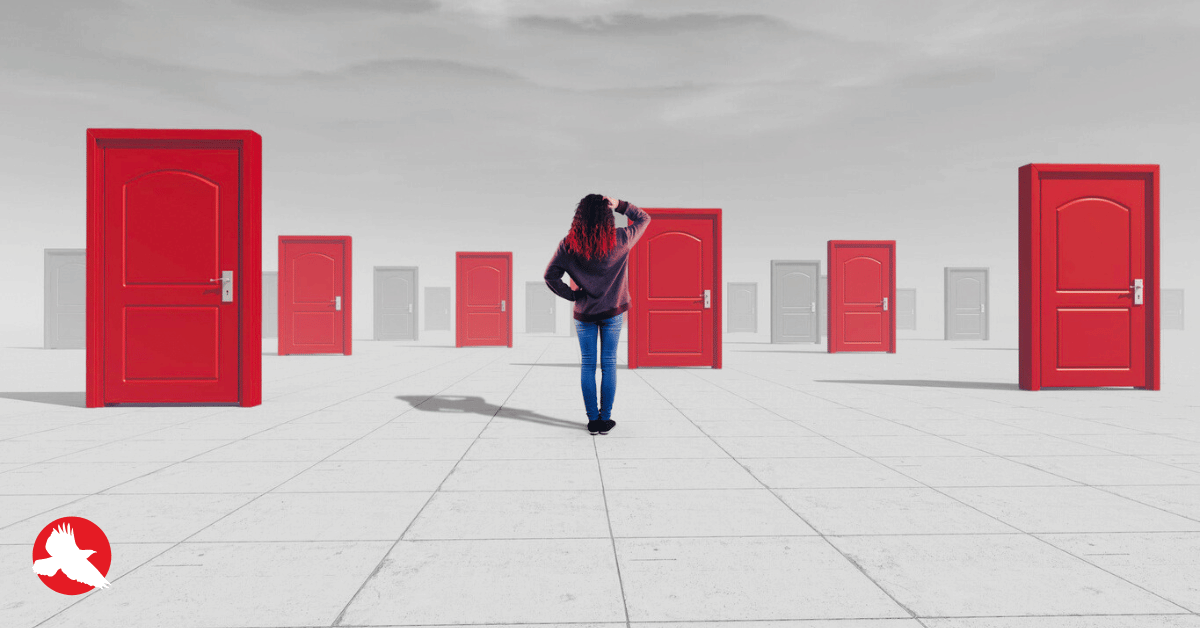 Executive standing at a decision point facing multiple paths after a product prototype